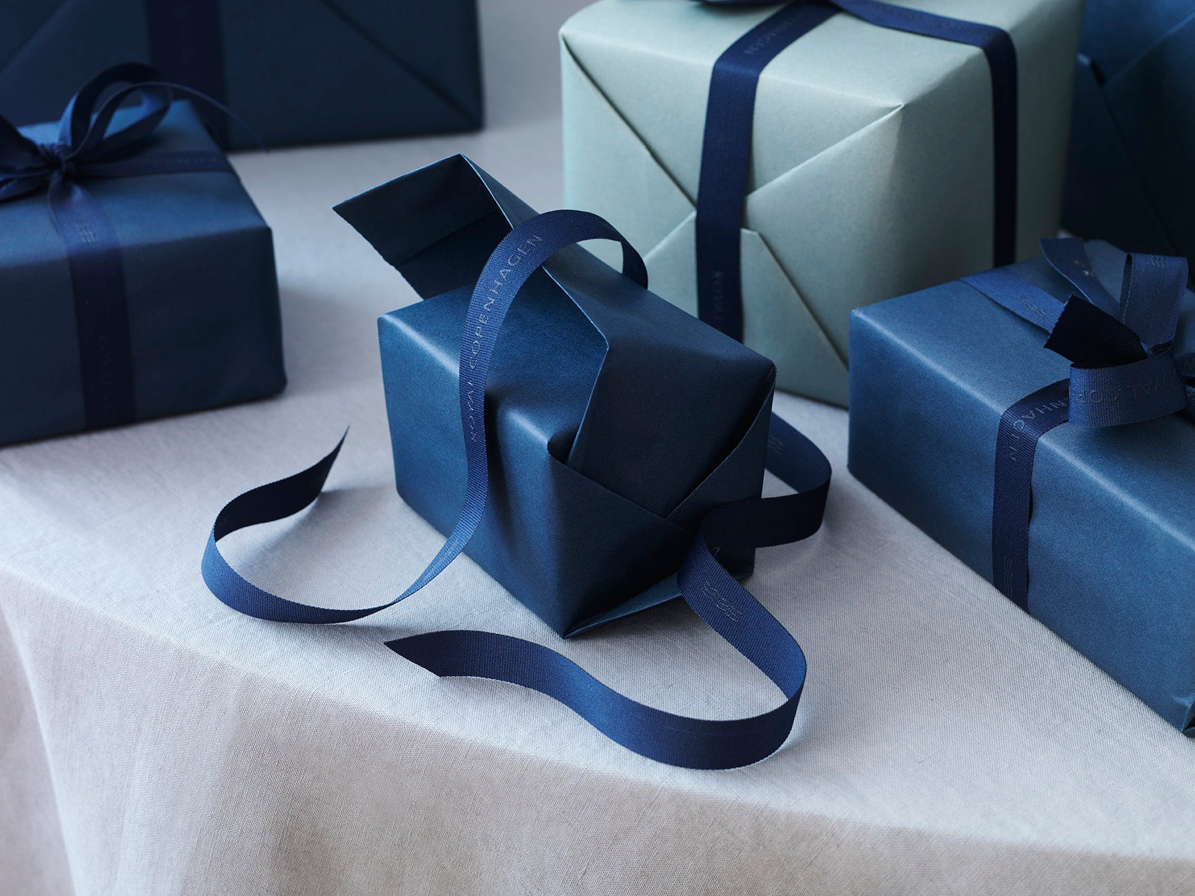 Blue gift with ribbon on a white surface
