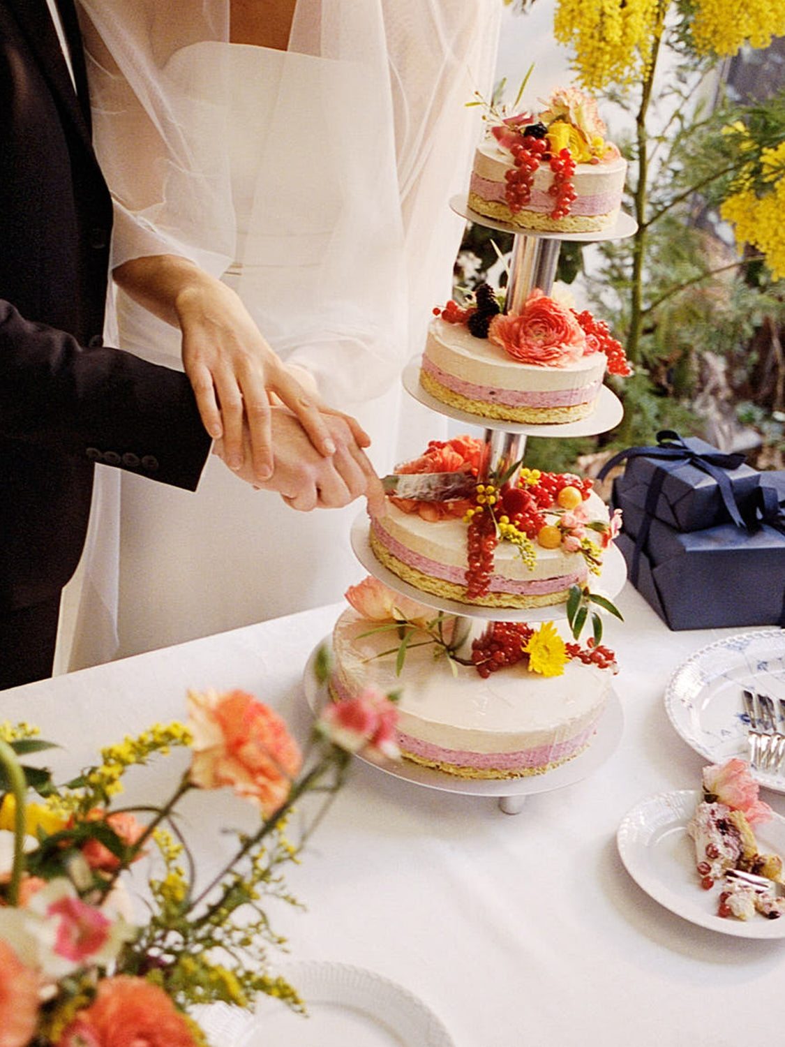 Cutting the wedding cake with floral decorations