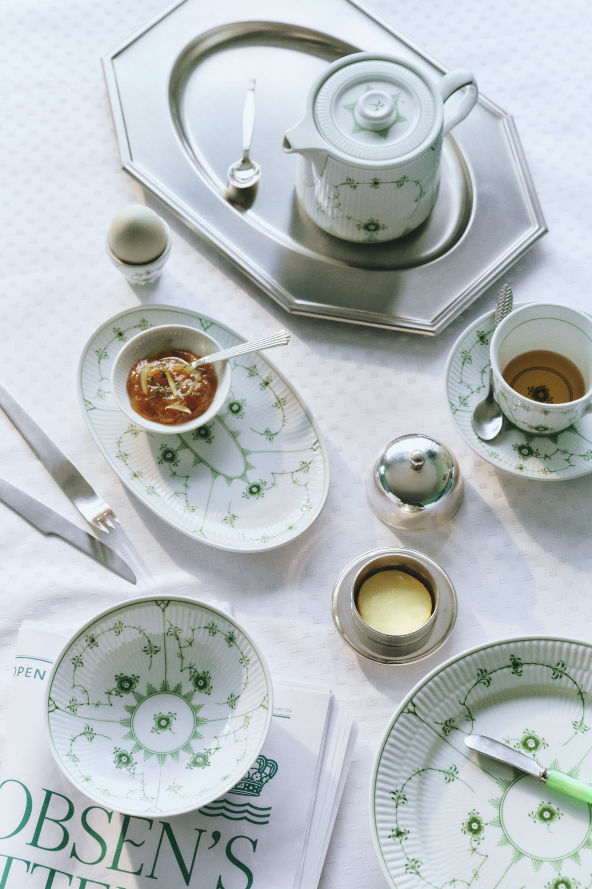 A breakfast table set with Green Fluted Plain porcelain from Royal Copenhagen