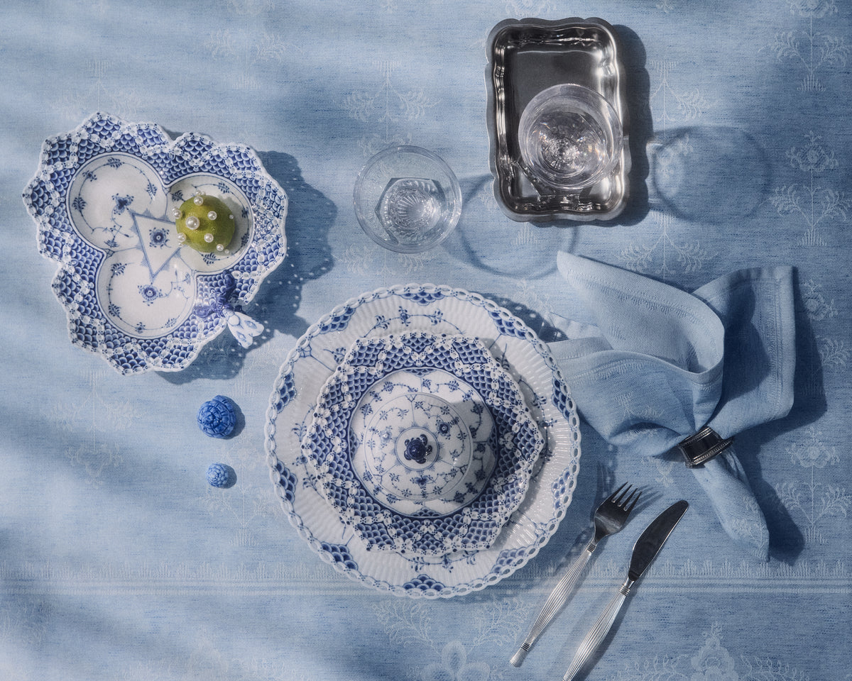 Porcelain from Blue Fluted Full Lace seen from above and framed u the Heritage Textiles in light Blue.