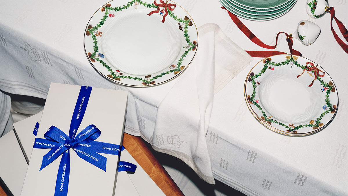 Star Fluted Christmas plates and gifts on a table